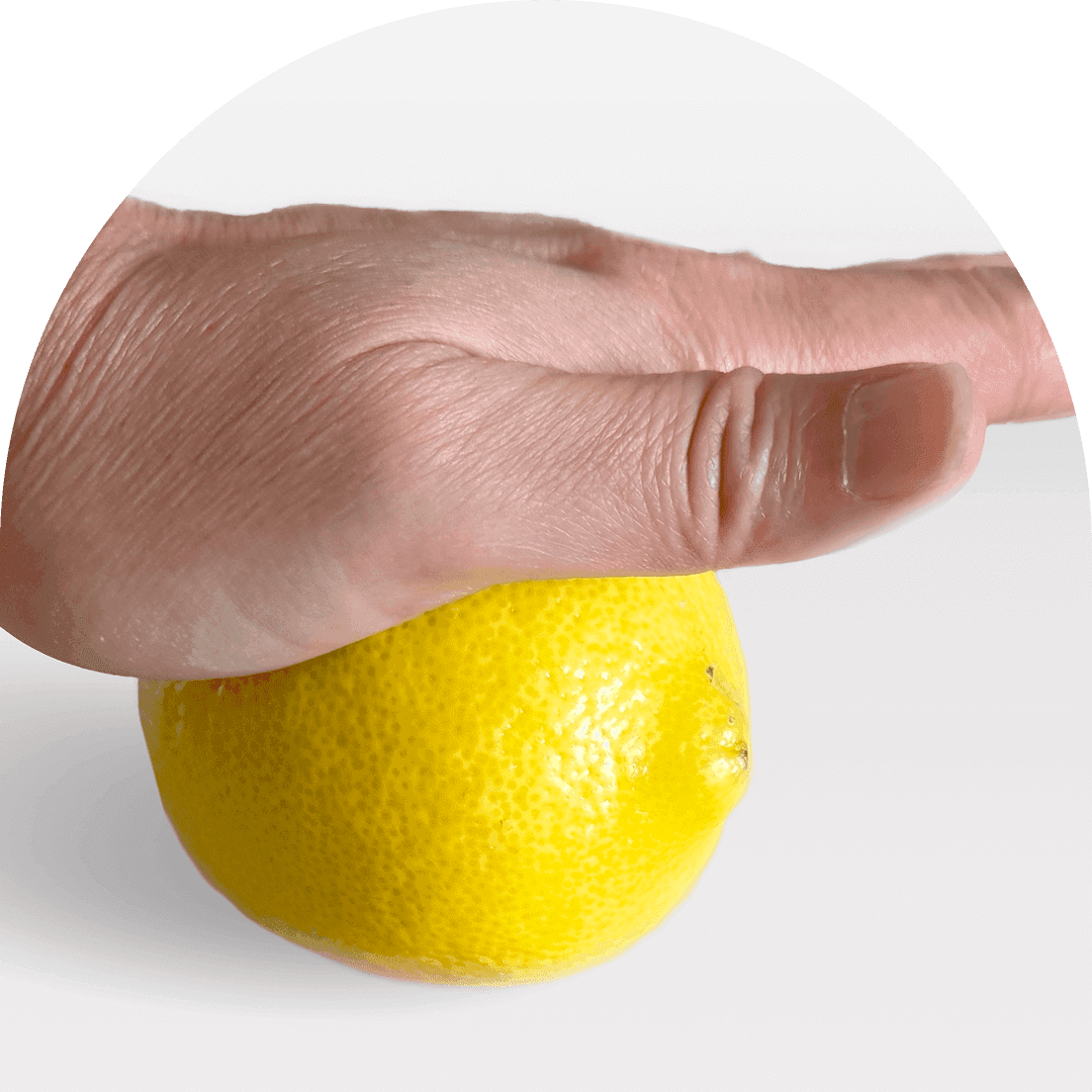 Hand squeezing a lemon